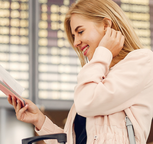 Happy woman claiming for delayed flight under regulation UK261